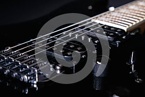 Close-up of a humbucker. Detail of six-string electric guitar, soft focus