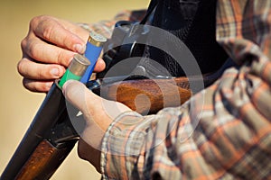 Close-up of a hunter loading his shotgun