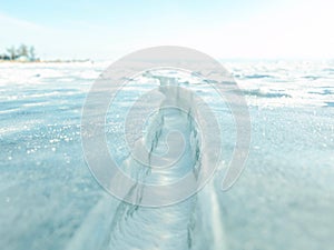 Close-up of ice crack surface; and horizon and blue sky behind