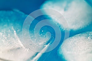A close up of ice cubes in a blue liquid