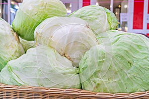 Close up of iceberg lettuce being sold at a farmer`s market, in a pile