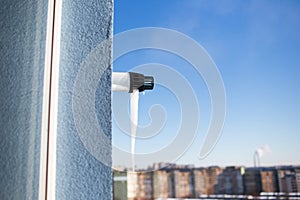 Close-up of icicle on gas boiler chimney in winter time. Flue of gas boiler in apartment