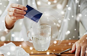 Close up of ill woman pouring medication into cup