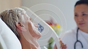 Close up of an illl senior man lying in a hospital bed