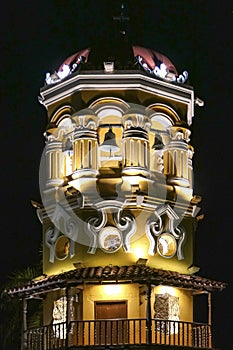 Close-up of illuminated clock tower of church of Saint Barbara at night, Santa Cruz de Mompox, Colombia, World Heritage