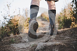 Climber legs make a last steps before peak