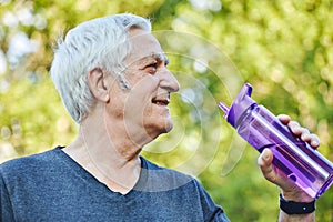 Close up image attractive mature man holds plastic reusable bottle