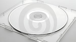 A close up shot of a blank white compact disc in a clear plastic case open