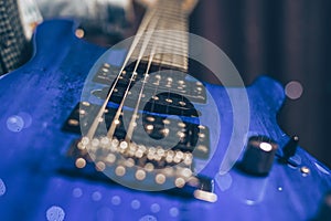 Close-up image of a blue electric guitar