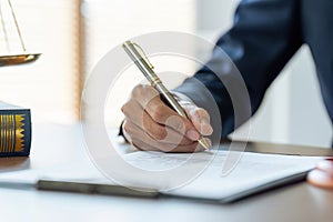 Close up image of businessman hand putting personal signature on contract document