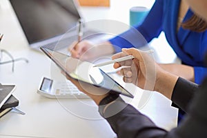 Close-up image of a businesspeople using portable tablet touchpad