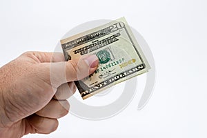 An a close up image of a Caucasian male hand holding a ten Dollar note with a plain background.