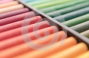 Close-up image of colorful chalk pastels in box