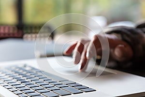 Close up Image of Computer and Hand of Person scrolling Touchpad