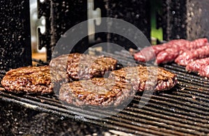 Close-up image of delicious juicy burgers on grill.
