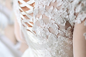 Image of the detailed laces on the back of a wedding dress. Soft fous on lace photo