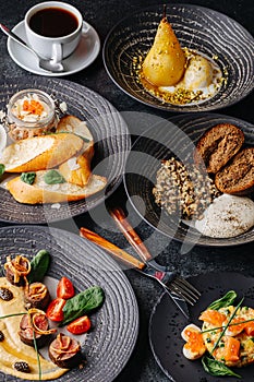 Close up image of a dinner table. Meat, salads, icecream dessert and coffee