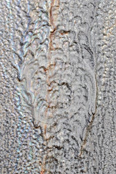 Close-up image of dried running grey-blue protective paint