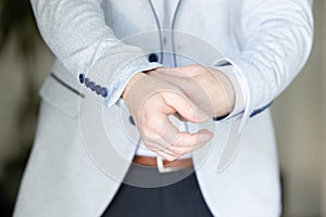 Close up image of a fashion the hands of a young businessman, handsome model man in casual cloth costume. Wearing the