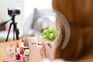 Close-up image, Female beauty blogger influencer testing lipstick on her hand