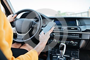 Close up image with female driver and blank phone screen