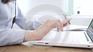 Close up image female hands typing on laptop keyboard