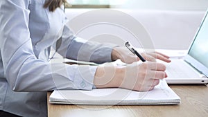 Close up image female hands typing on laptop keyboard