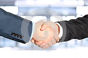 Close-up image of a firm handshake between two colleagues