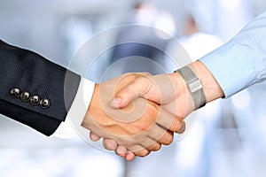 Close-up image of a firm handshake between two colleagues