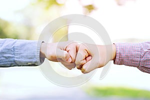 Close up image of a fist bump collide agreement