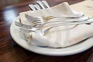 Close up image of forks and knives served on table
