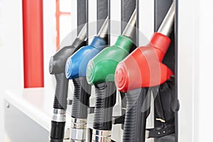 Close up image of four gas pumps with different types of fuel on gas station