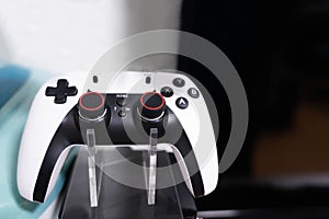 Close-up image of a game controller, video game joystick placed on a stand for a gamer