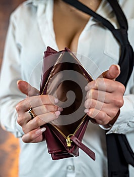 Close-up image of girl& x27;s hands with an open empty purse in her hands.