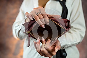 Close-up image of girl& x27;s hands with an open empty purse in her hands.