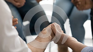 Close up image group of people holding hands praying