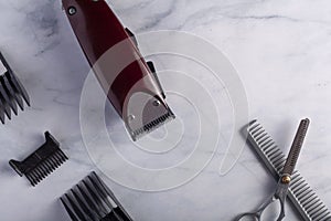 close up image of a hair trimming kit featuring a corded electrical hair clipper with different sizes of comb guards