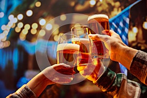 Close up image of hands holding glasses of beer and clinking after celebrating toast. Old friends sitting in bar and