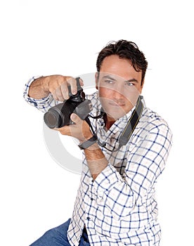 A young man holding his camera ready for a shoot