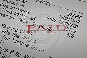 Close up image of heating oil invoice marked paid. photo