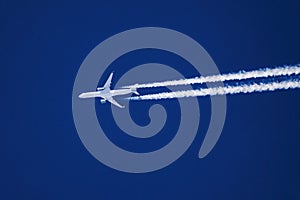 Close-up image of a high altitude jet with contrails