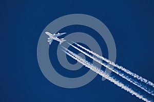 Close-up image of a high altitude jet with contrails