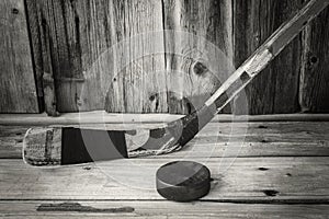 Close up image of a hockey stick and puck.