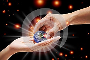 A close up image of a human hand holding a light-emitting planet Ecology concepts And changing the world,Elements of this image photo