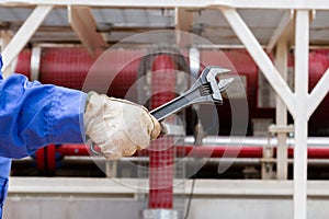 Close-up image of human hand holding wrench