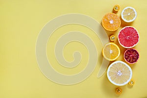 Close up image of juicy organic assorted sliced citrus fruits, visible core texture, bright paper textured background, copy space