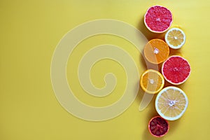 Close up image of juicy organic assorted sliced citrus fruits, visible core texture, bright paper textured background, copy space