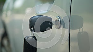 Close-Up Image with Keys and Remote Control in the Car Door Lock