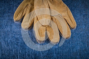 Close up image of leather brown protective gloves