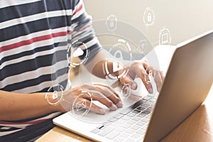 Close-up image of male hands using computer laptop with icon graphic cyber security